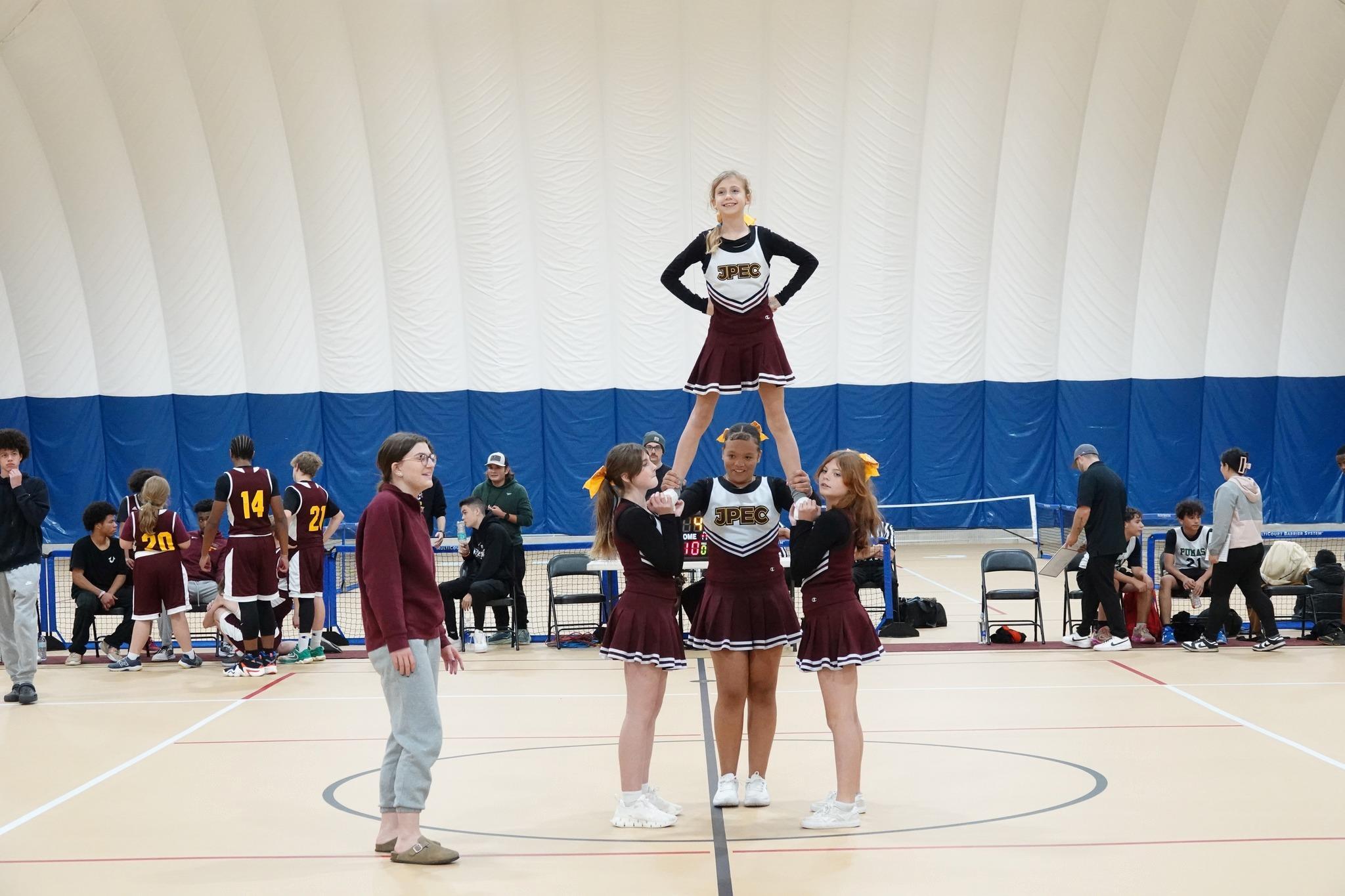 jpec cheerleaders at basketball game in a pyramid